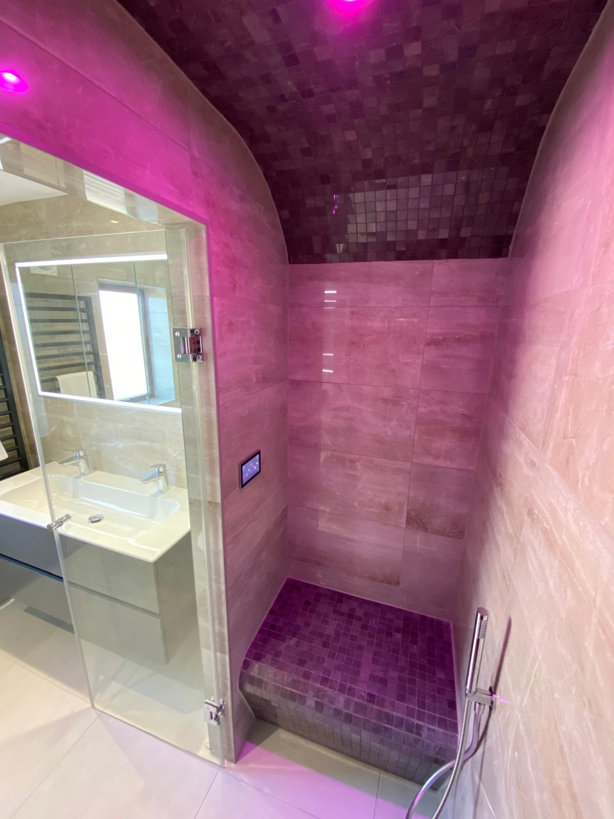 Luxury steam room in Leeds with illuminated seating and rainfall shower