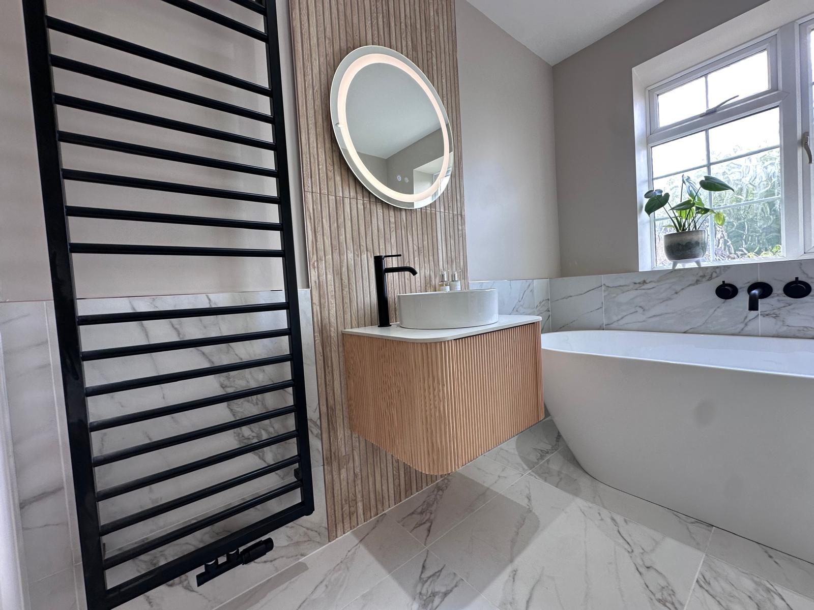 Marble-effect luxury bathroom in York with brushed brass details